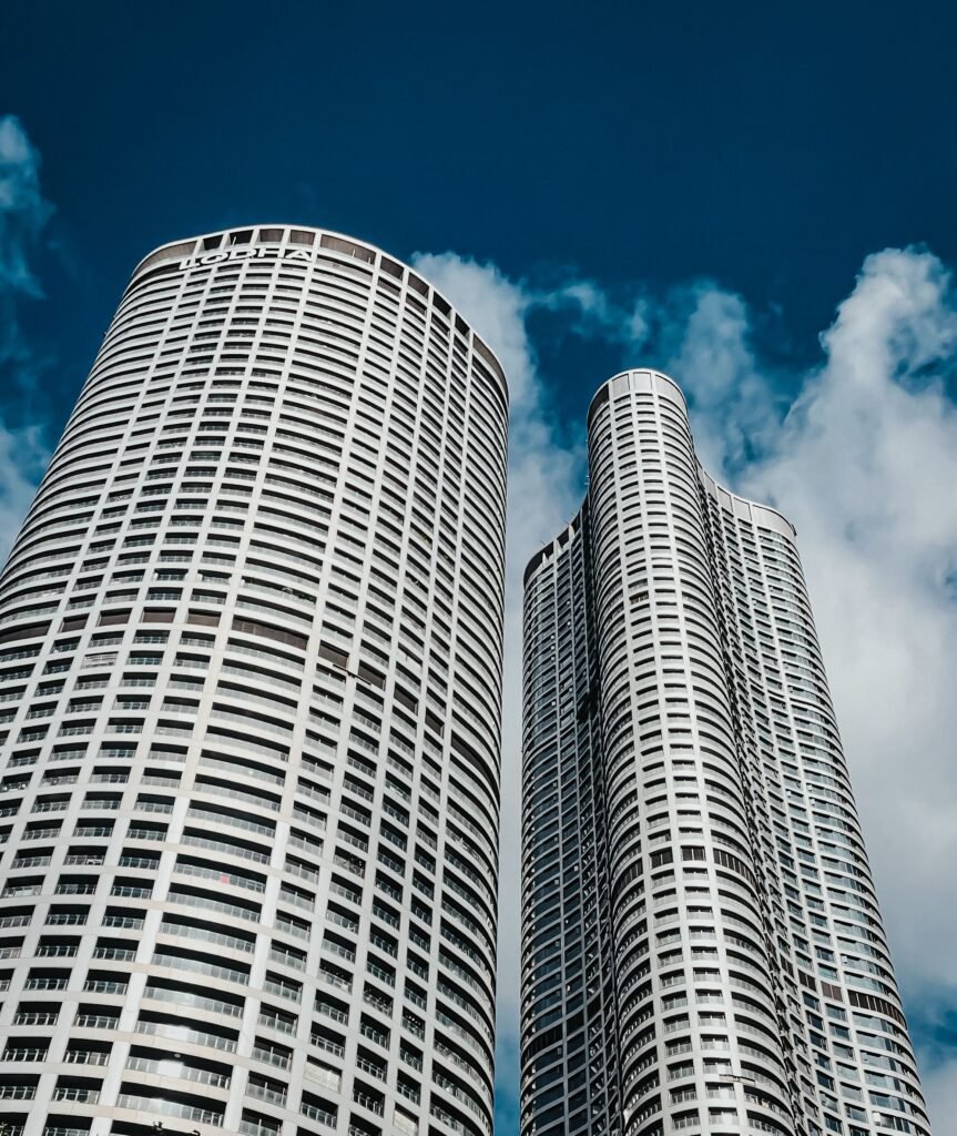 pexels-photo-17239829-17239829 Low angle view of modern skyscrapers with a blue sky background, showcasing urban architecture.